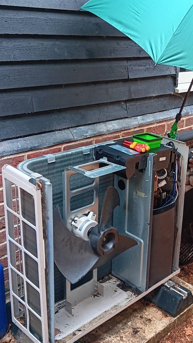 Open air source heat pump during servicing by Ecofox Energy